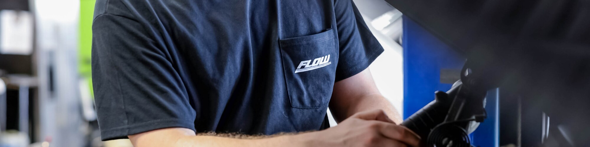Acura service technician wearing a Flow Acura service shirt